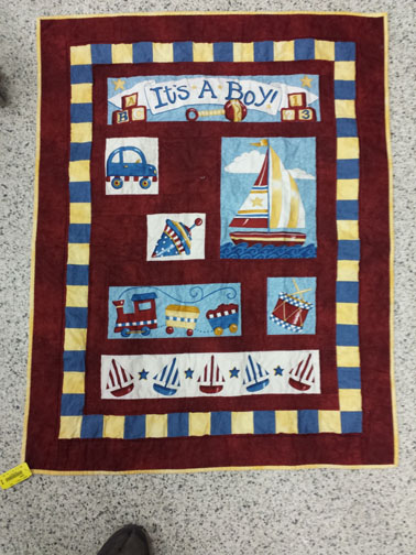 Baby quilt with sailboats.
